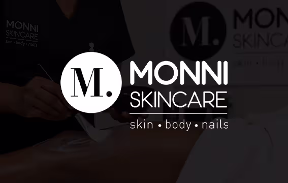 Monni Skincare logo over a dimmed photo of a beauty treatment in progress