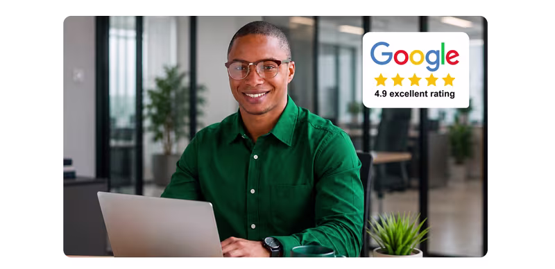 Business owner working at a laptop, showing a 4.9 star Google rating for website management services
